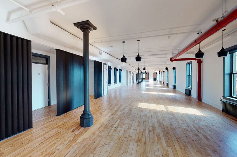 Long loft floor with black fluted partitions and cast-iron columns