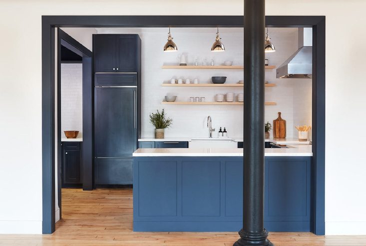 Pantry with blue cabinetry and open shelving